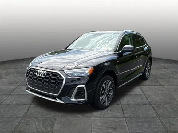 Black 2023 Audi Q5 in a plain photo booth